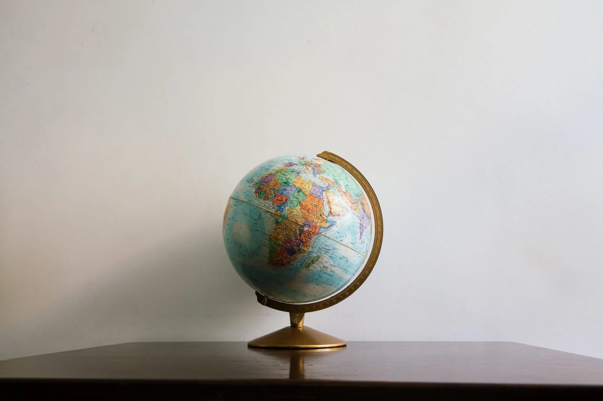 Canva Globe model on dark wooden